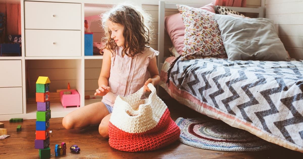 girl playing with toys in her bedroom