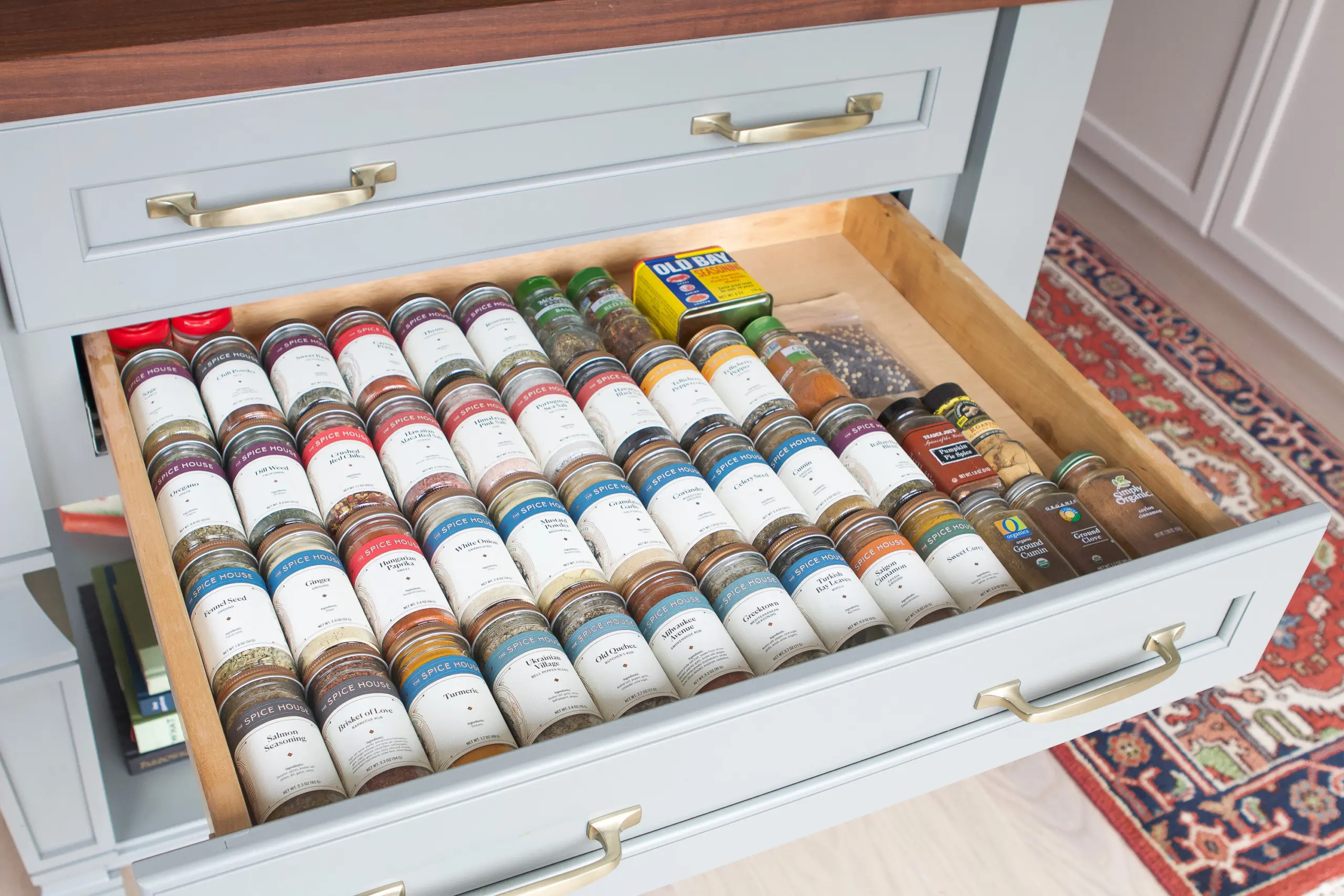 openned grey drawer with organized spices